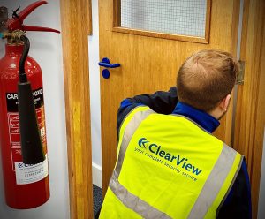 CrystalView Services employee undertaking fire door inspection