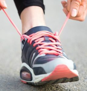 Hands tying running shoes shoelaces