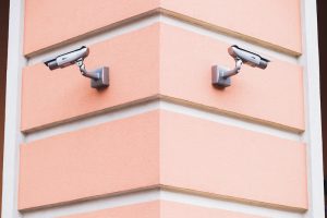 Street camera surveillance at the corner of the house. Symmetrically pointing in different directions.