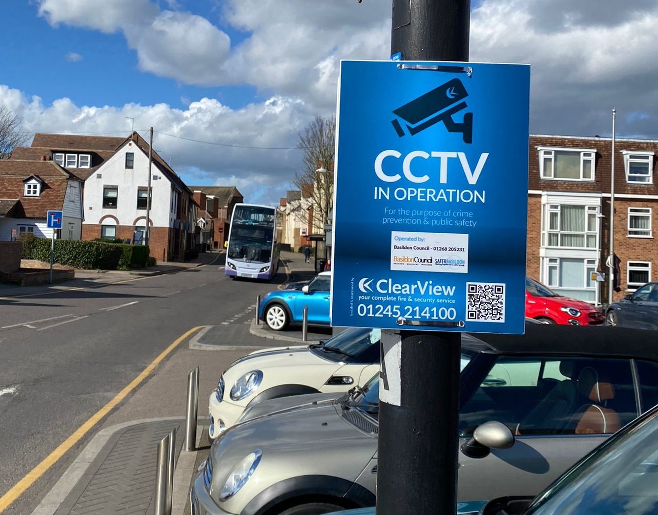ClearView CCTV Cameras in Operation sign displayed on a post in a busy street